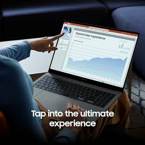 Person pointing at user experience graph on laptop screen.