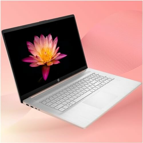 Laptop with a flower wallpaper on a pink background