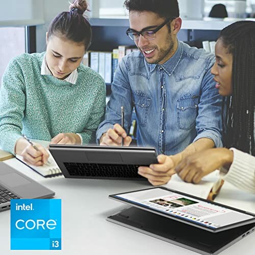 Group of students collaborating with a tablet at a table.