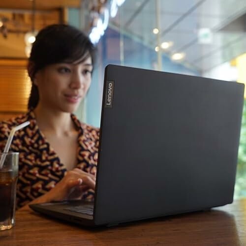 Woman using a Lenovo laptop in a cafe